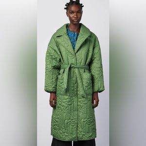 A midi length coat with floral stitched quilting & tulip detailed front pockets.